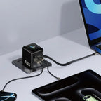 Efficient 70W GaN power adapter from Dreams Setup charging multiple devices on a desk, featuring a compact design and digital display.