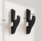 Technical diagram showing the dimensions of black katana wall mounts, featuring a 15cm height and 7cm hook width for gaming room display by Dreams Setup.