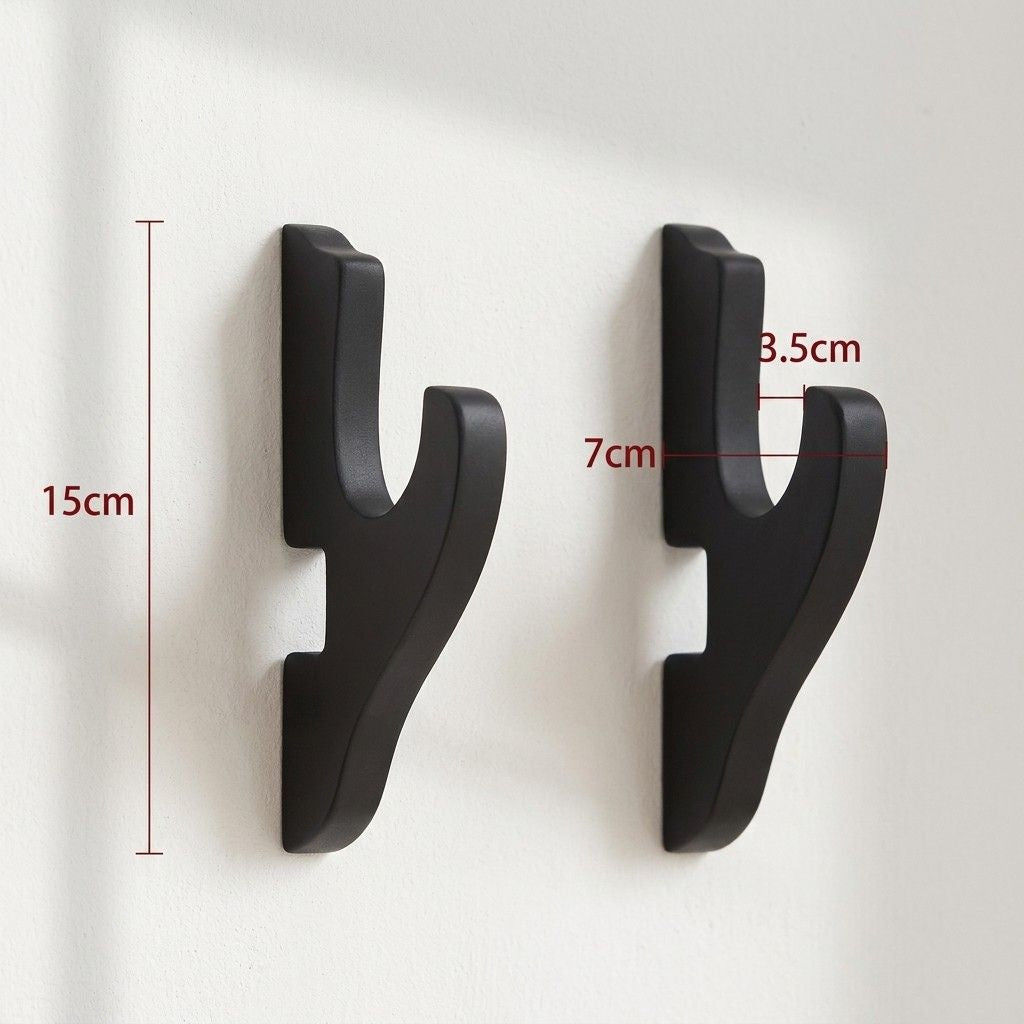 Technical diagram showing the dimensions of black katana wall mounts, featuring a 15cm height and 7cm hook width for gaming room display by Dreams Setup.