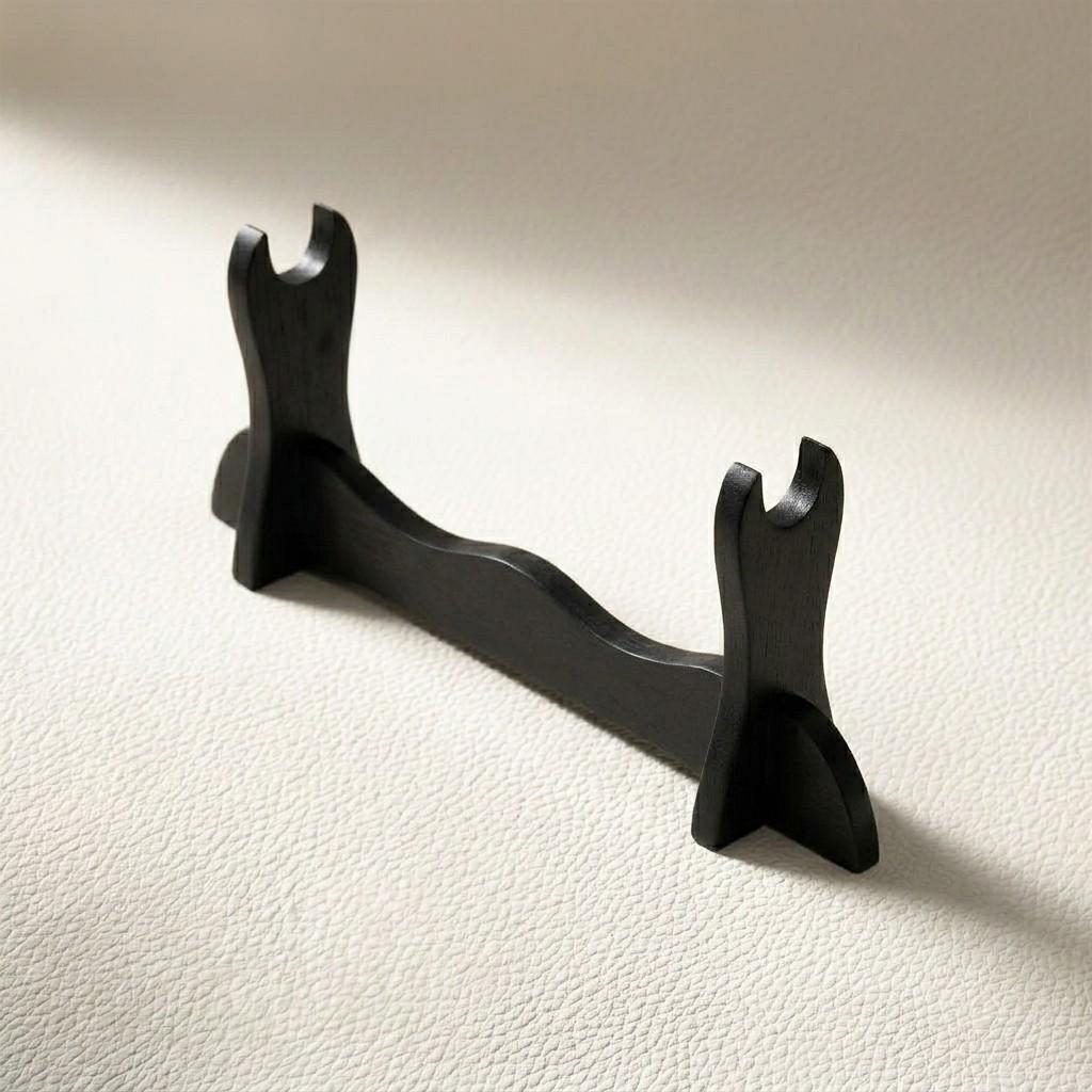 A sleek black wooden desk stand for katana display, fully assembled on a light textured surface, designed for gaming setups by Dreams Setup.